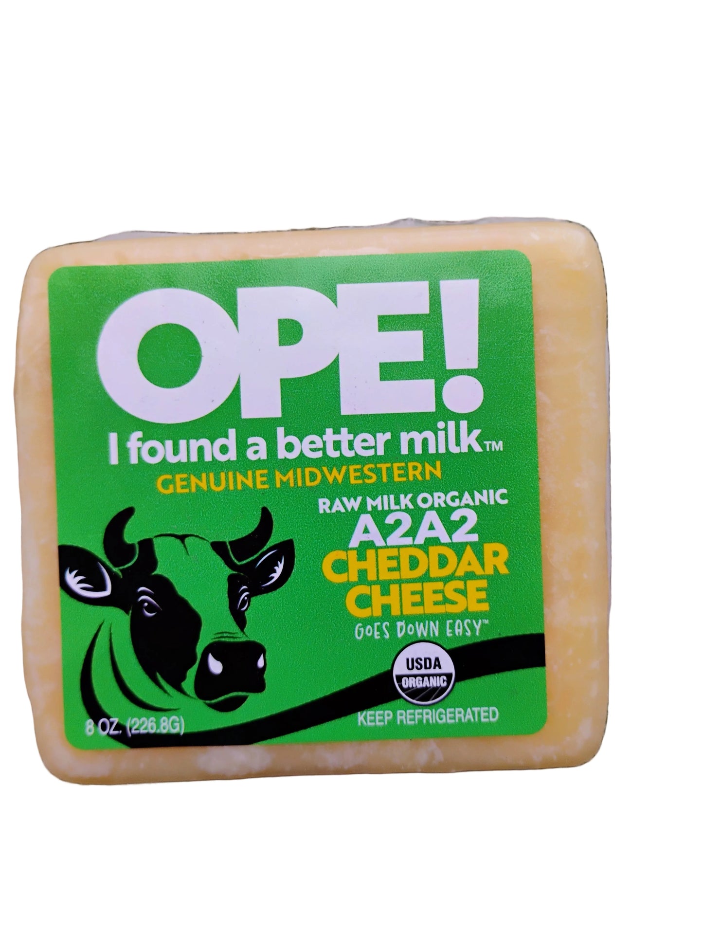 Block of cheese with a green label on a white background